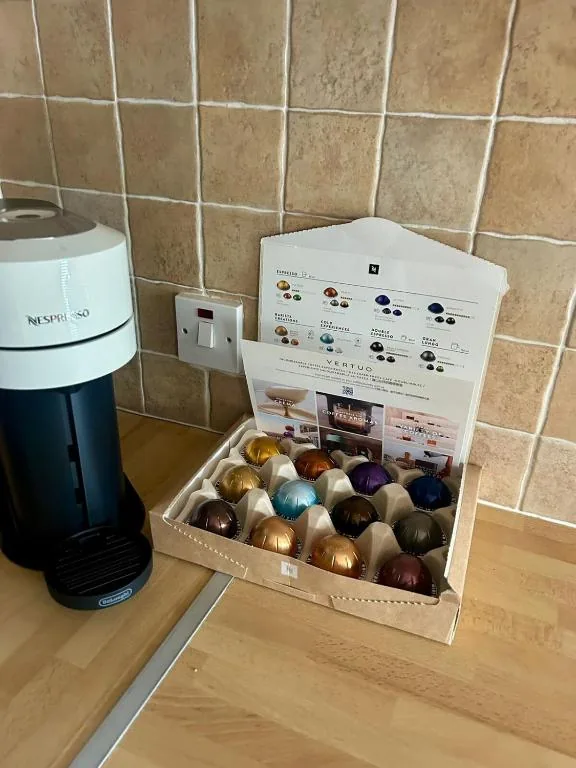 Coffee machine and capsules ready for guests