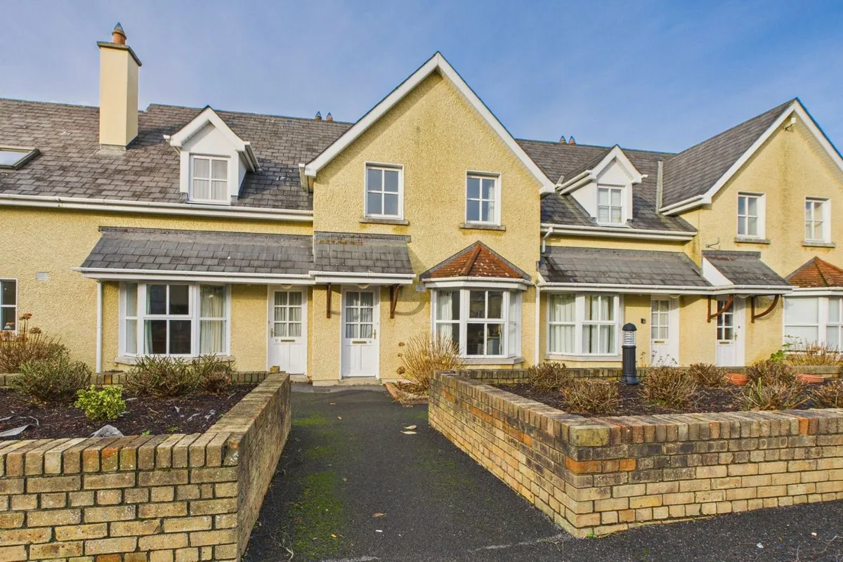 Front of the stone-faced mews terrace at Bolton Mews with parking at the door