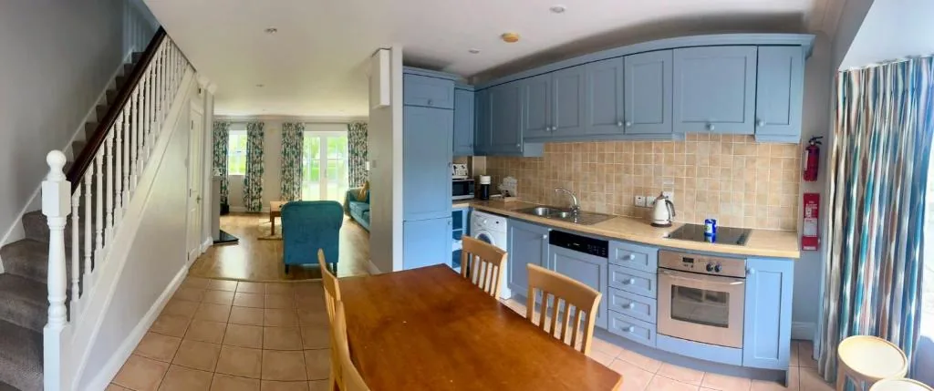 Kitchen and dining area with pale blue units